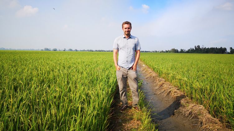 Description: Dr Robert Caine in a rice field in Vietnam